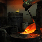 Lost wax casting - pouring the liquid bronze into a mold